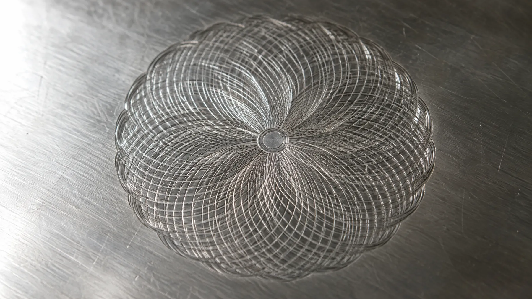 Macro photograph of an engine-turned rosette cut into silver